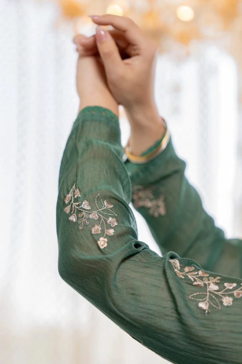 Elegant emerald green Anarkali suit with delicate floral embroidery and flowy silhouette.
